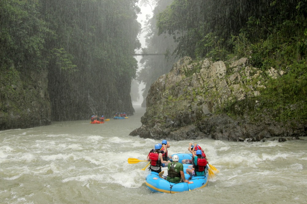 A group of people in rafts on the water.