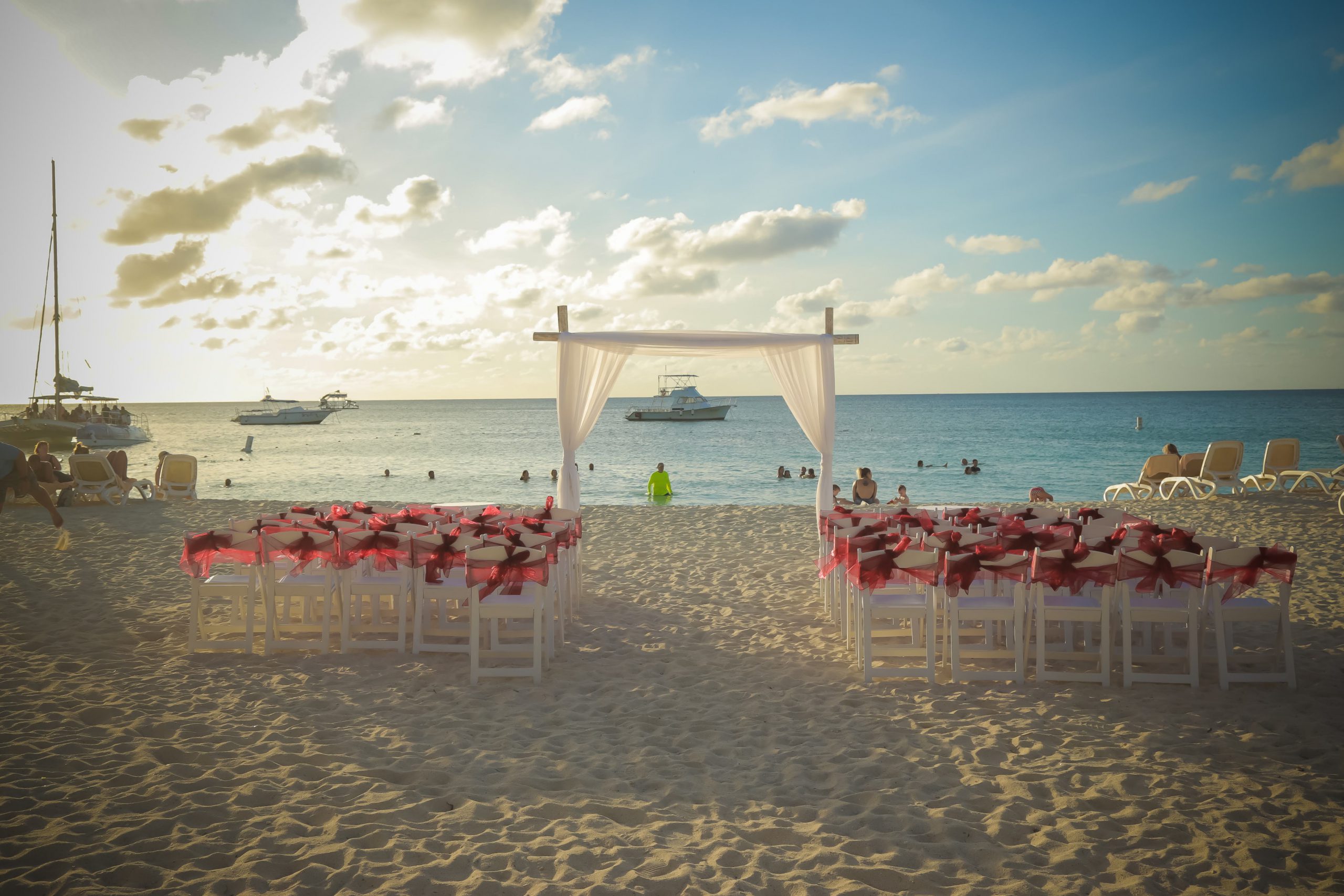 A beach with chairs and tables set up for an event.
