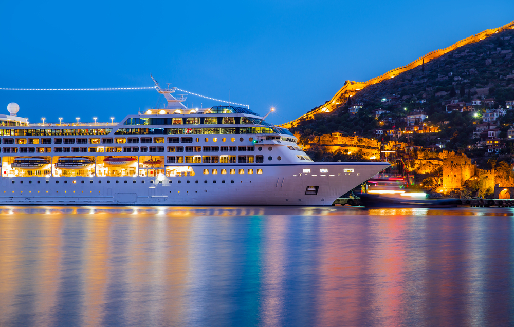 A large cruise ship is docked in the harbor.