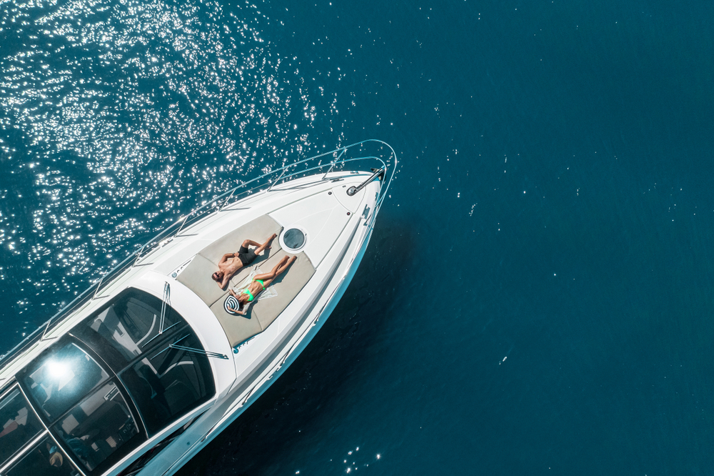 A person laying on the boat in the water.
