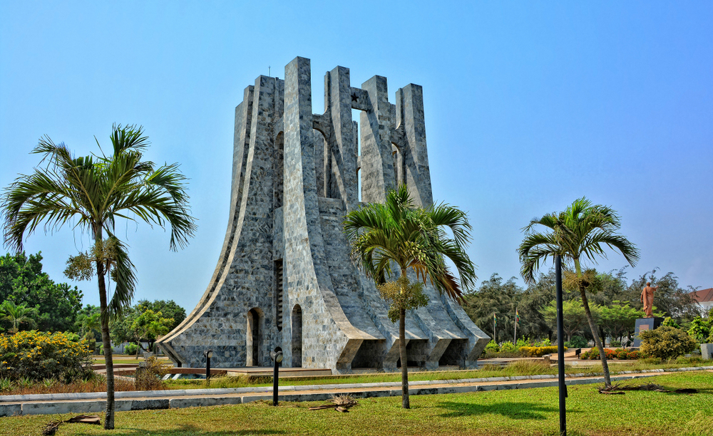 A large stone structure with trees in the background.