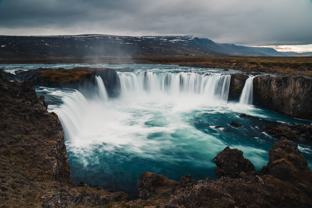 A waterfall with water pouring over it