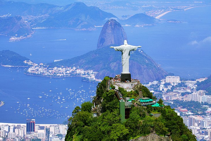 A view of christ the redeemer statue and some buildings.